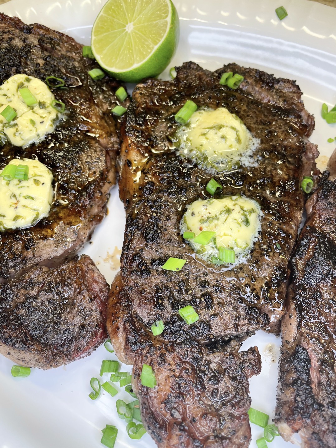 Merrick’s Grilled Ribeyes with Charred Scallion Citrus Compound Butter