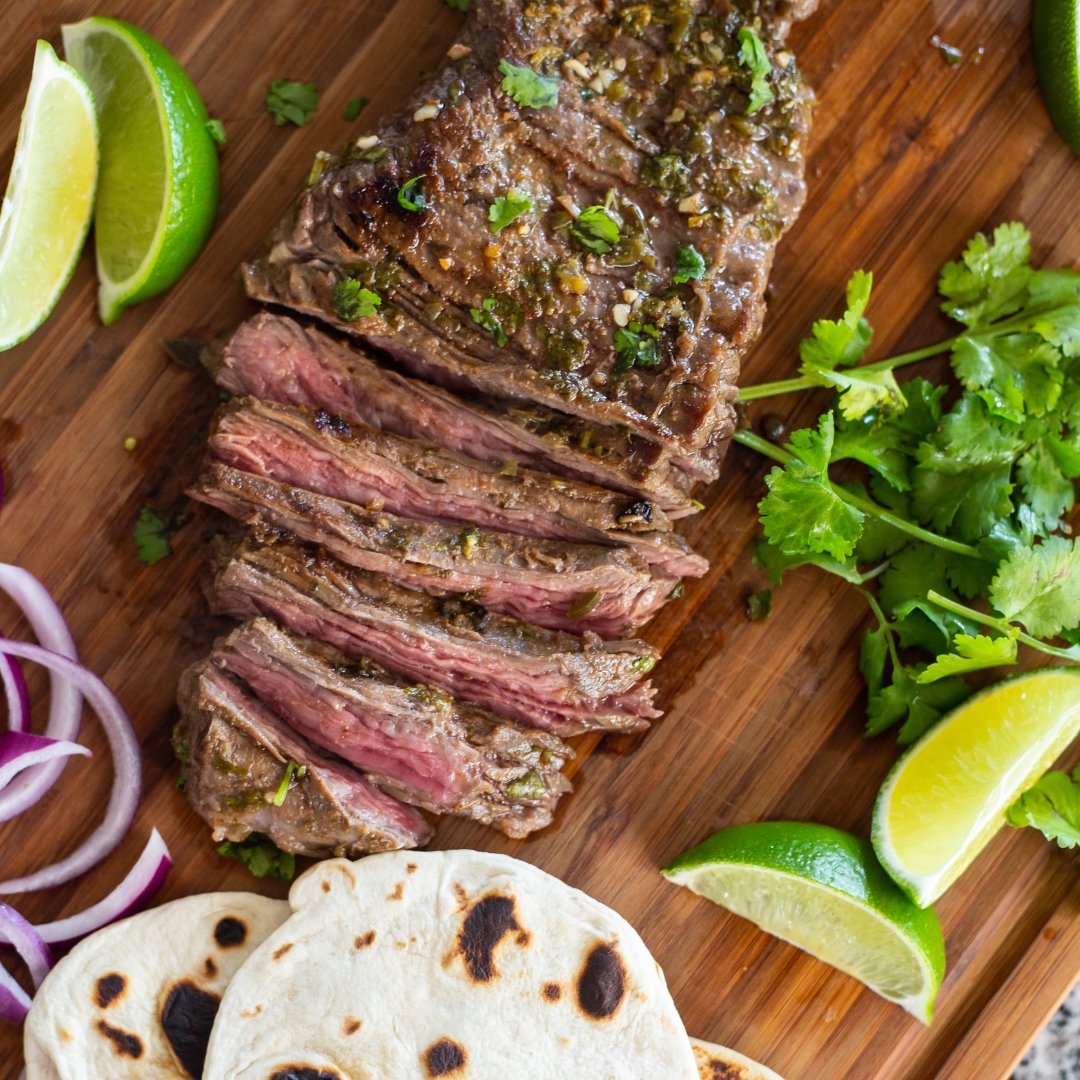 Marinated barbecue meat on skewer. Shish kebab or Shashlyk meaning skewered  meat. Beef or pork on grill on an open fire with smoke. Street food, picnic  concept Stock Photo